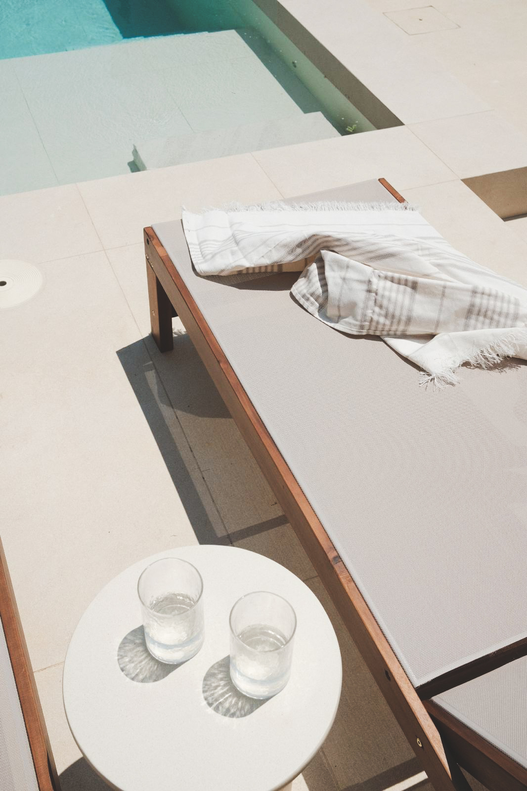 Wooden sun lounger by the pool