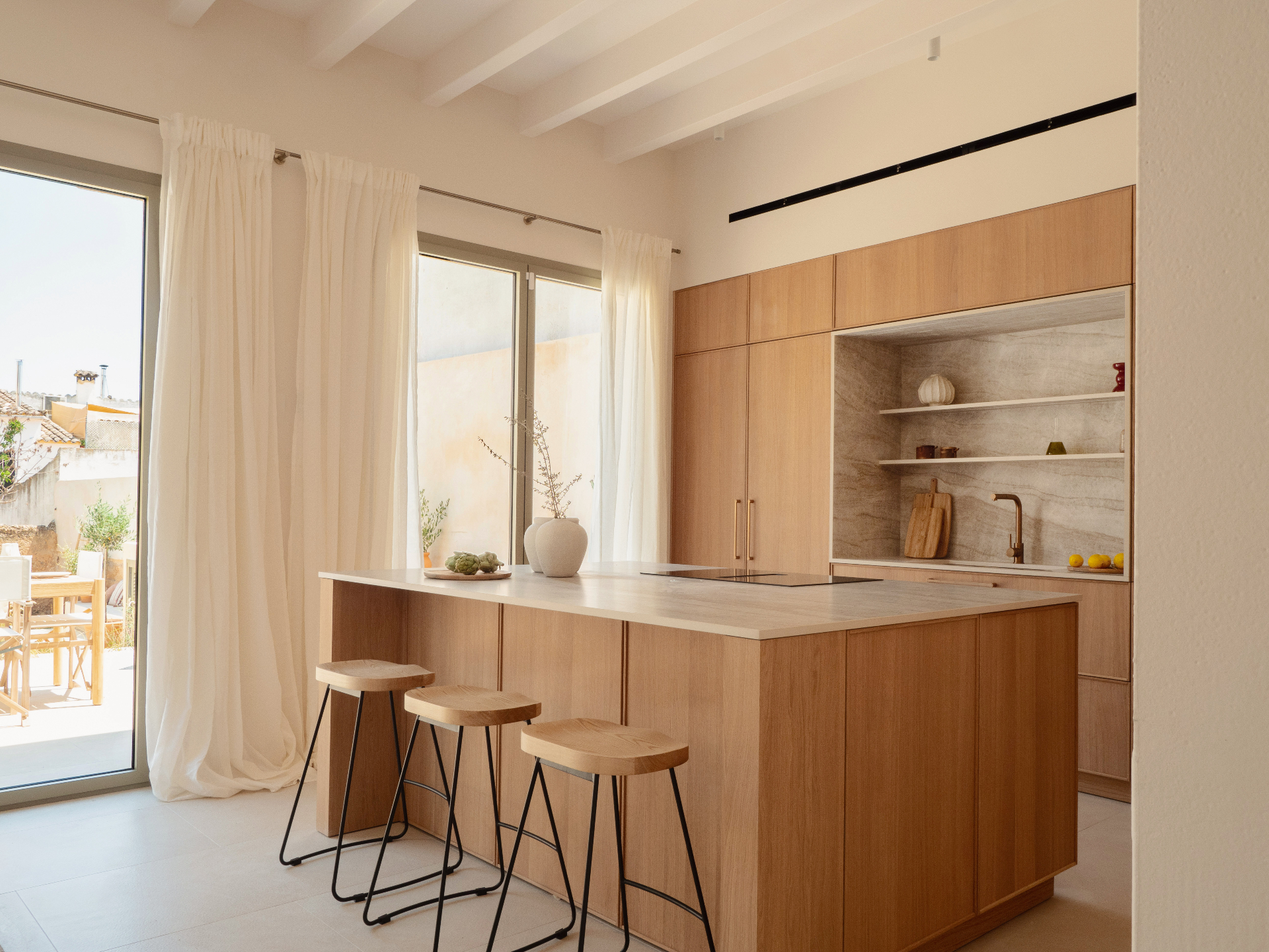 Kitchen with oak cabinetry and stone backsplashes